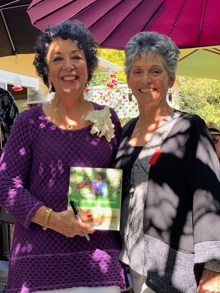 The Lifelong Gardener book contributor, Suki Munsell congratulating author Toni Gattone.