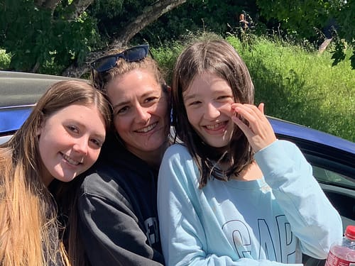 Our daughter Erin and our granddaughters Maddie and Caitlyn smile for a photo during their social distancing visit with us.