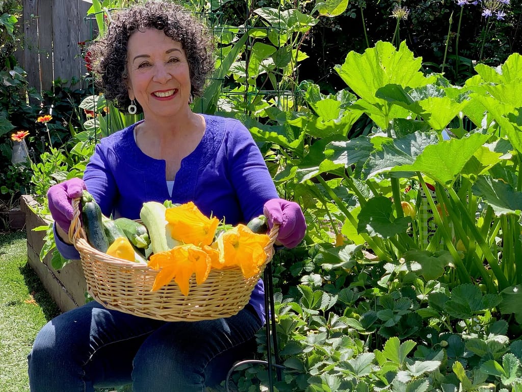 Author and gardener Toni Gattone shows off a basket of vegetables